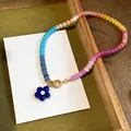 Macro view of colorful dopamine glass beaded necklace with blue flower pendant accessory - Deep Blue Multicolor Necklace