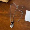 Detail of silver heart pendant necklace with 'Eternal my love' engraving and black bead - Obsidian Heart Pendant / Silver