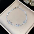 Close-up of elegant silver butterfly bracelet with sparkling zircon stones on gift box - Silver-White