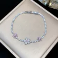Close-up of a luxury silver-tone bracelet featuring pink and white zircon flower motifs. - Silver-Pink-Flower