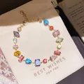 Close-up detail of a colorful zircon geometric link bracelet on a cream gift pouch - 13# Bracelet