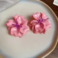 Close-up detail of stylish pink acrylic 3D flower earrings with purple beaded centers - 3D Floral (Silver Post) / Pink
