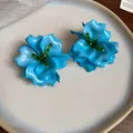 Detailed macro view of vibrant blue 3D acrylic flower earrings with green beaded centers. - 3D Floral (Silver Post) / Blue