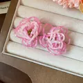 Close-up of pink handmade glass beaded flower stud earrings in jewelry box - Pink