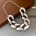 Close-up detail of a silver-toned chunky hip-hop chain necklace with shiny finish - Silver