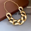 Detail view of a chunky polished gold chain necklace featuring hip-hop punk style - Gold