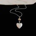 Close-up of silver heart pendant with Eternal my love engraving on black velvet - Heart Pendant / Silver