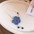 Handmade woven blue flower pendant necklace with beads and wooden accents for vacation - Blue