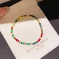 Elegant gold-plated bracelet with colorful geometric zircons on a white pouch - Style 15 Bracelet