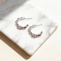 Close-up detail view of silver C-shaped stud earrings featuring pink zircon candy accents. - C-Shaped Zirconia Style (HE32402) / Silver-Pink