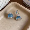Detailed macro view of exquisite blue resin pudding earrings with colorful zircon stones - Asymmetric Earrings / Blue