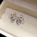 Close-up of elegant floral stud earrings with sparkling zirconia and pearl in a jewelry box - White Flower Style (45#) / Silver