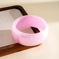 Close-up of translucent pink resin bangle with smooth rounded finish - Light Pink