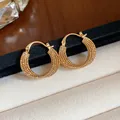 Detailed macro shot of textured 18k gold plated hoop earrings on velvet - Hoop Earrings (HE32047) / Gold
