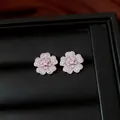 Detailed view of elegant flower stud earrings with pink and white zircons in a box. - Stud Earrings / Silver-Pink