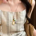 Detail view of ethnic botanical acorn pendant necklace with woven cord for women - Acorn Lemon Style (5#) / Brown