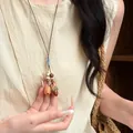 Detailed view of a handmade forest-style long necklace with natural acorn and nut pendants. - Acorn Walnut Style (6#) / Brown