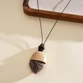 Close-up detail of Bohemian retro heart pendant necklace with acrylic and leather cord - Acorn Heart Style / Black-Khaki