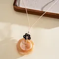 Close-up of bohemian acrylic pendant necklace with layered marble-textured button discs - Double Layer Marble Disc Style / Brown-Khaki