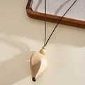 Close-up of bohemian acrylic petal pendant with brown cord and gold beads. - Petal Waterdrop / Khaki