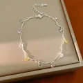 Close-up of a silver chain bracelet featuring multi-colored round zircon charms - Bracelet / Silver - Rainbow