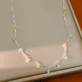 Close-up of a silver necklace featuring vibrant multi-colored round cubic zirconia charms - Necklace / Silver - Rainbow