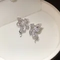 Detailed close-up of shiny zircon butterfly wing ear cuffs on white velvet background - Butterfly Style Pair / 2.2*1.3cm / Silver