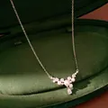 Detail shot of elegant silver pearl necklace with zircon teardrop in green velvet box - Teardrop Pendant / Silver