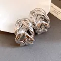 Close-up detail showing the metallic texture of chunky silver-toned chain-link C-shaped earrings - Silver Pin - Stud Earrings / Silver