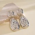 Close-up view of silver oval pendant earrings with retro abstract embossed pattern - Silver Lava Fluid Relief Oval Style (13#)