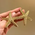 Macro view of vintage textured golden starfish earrings with elegant beaded metal surface - Gold Starfish Dense Granular Texture (19#)