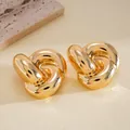 Macro detail of polished gold-toned knot stud earrings showing high-quality shine - Gold Mirror Polished Knot Style (21#)