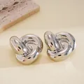 Detailed macro shot of elegant polished silver twisted knot stud earrings on neutral background - 3D Knot Spiral Twist Design (22#)