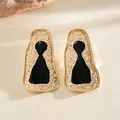 Close-up of vintage gold hammered earrings with black enamel center detail - Gold Hammered Irregular Black Oil Drip (23#)