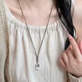 Vintage woven rope necklace featuring a fish shaped stone and heart charm pendant for women - White