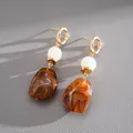 Close-up of vintage resin geometric drop earrings with brown marbled texture - Brown