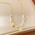 Detailed view of a yellow beaded necklace featuring a sparkling zircon flower pendant. - Necklace-Yellow / Yellow