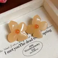 Detailed view of vintage apricot resin flower earrings with delicate orange centers - Flower Style (HE31872) / Yellow
