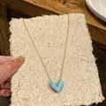 Detailed view of the 14k gold plated blue heart pendant necklace on a fine chain - Heart Clavicle Chain (HN11556) / Blue