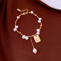 Close-up of 18K gold plated bracelet with freshwater pearls and Good Luck charm - 18K Gold Plated Pearl Bracelet / Gold with Beige
