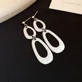 Elegant silver-toned geometric triple oval linked drop earrings on black fabric - Three-Section Irregular Oval Hollow Drop (42#)