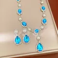 Elegant jewelry set featuring bright blue crystal teardrop earrings and a matching necklace - Necklace and Earring Set / Blue