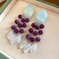 Detailed view of vintage tassel earrings with purple beads and white baroque pearls - Silver Needle-Blue-Purple