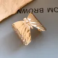 Detailed close-up of a gold butterfly cuff bracelet with exquisite pleated wing textures - Butterfly Shape Style (HB5608) / Gold