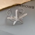 Close-up macro view of a silver starfish cuff bracelet featuring a textured beaded design - Sea Star Shape Style (HB5609) / Silver