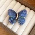 Macro view of blue embroidered butterfly hair clip showing intricate thread texture - Duckbill Hair Clips / Blue