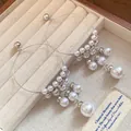 Detailed view of elegant French vintage silver hoop earrings with white pearl tassels - Silver Needle White Pearl Tassel Style / Silver