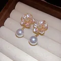 Detailed view of elegant pink flower pearl earrings with zircon centers in a box - Silver Needle / Gold Plated Pink