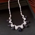 Detailed macro view of French vintage necklace with deep purple water drop zircons - Silver-Purple