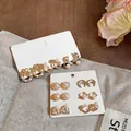 Close-up detail of mixed pearl and rhinestone stud earring sets on elegant display cards - 18-Piece Stud Earring Set / 18-Piece Set / Gold-White